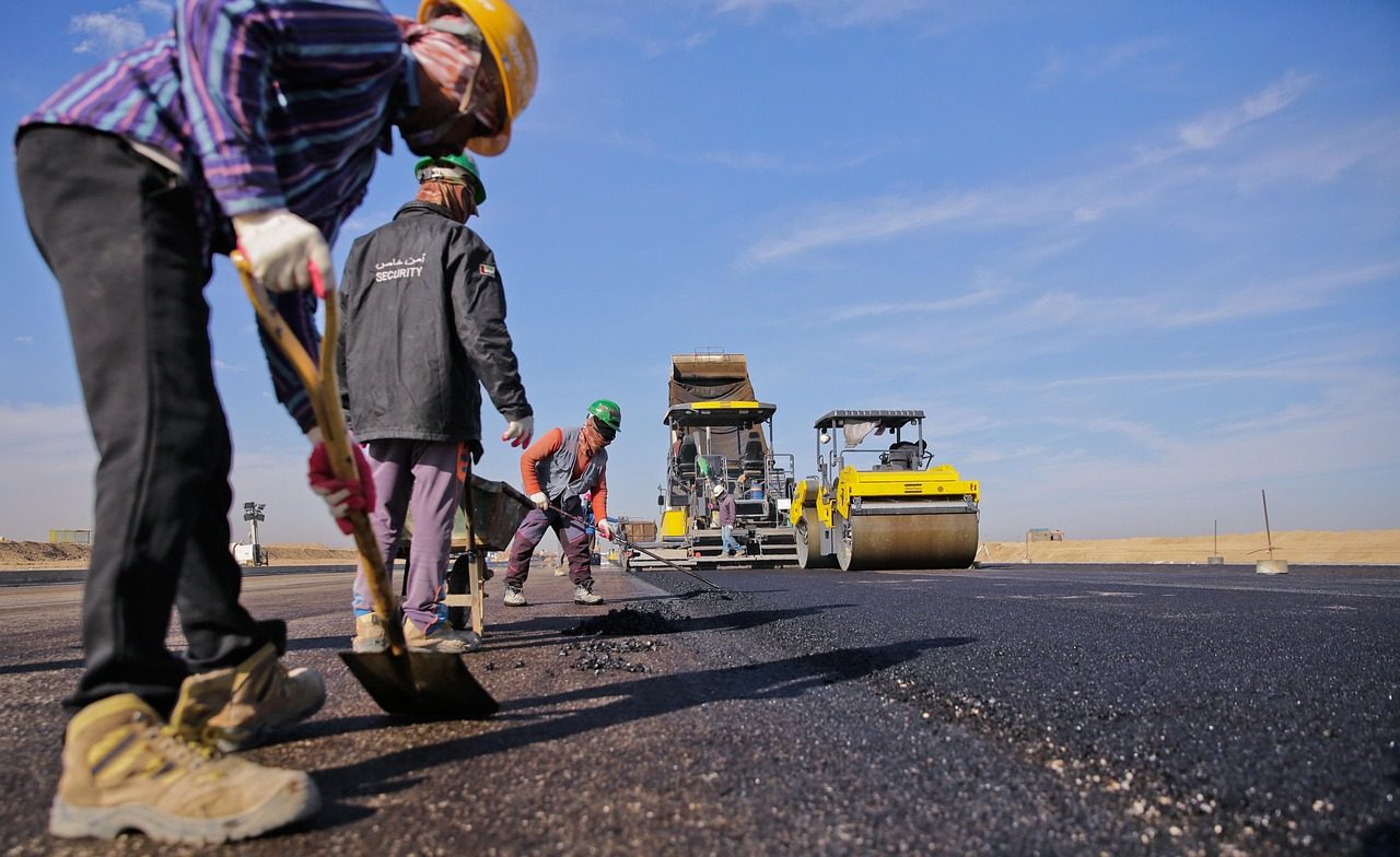Paving crew laying fresh asphalt in Huntsville